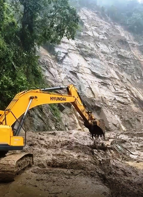 An excavator clearing up debri from one of the landslide hit stretches of the NH 29 Kohima-Dimapur road on September 15.